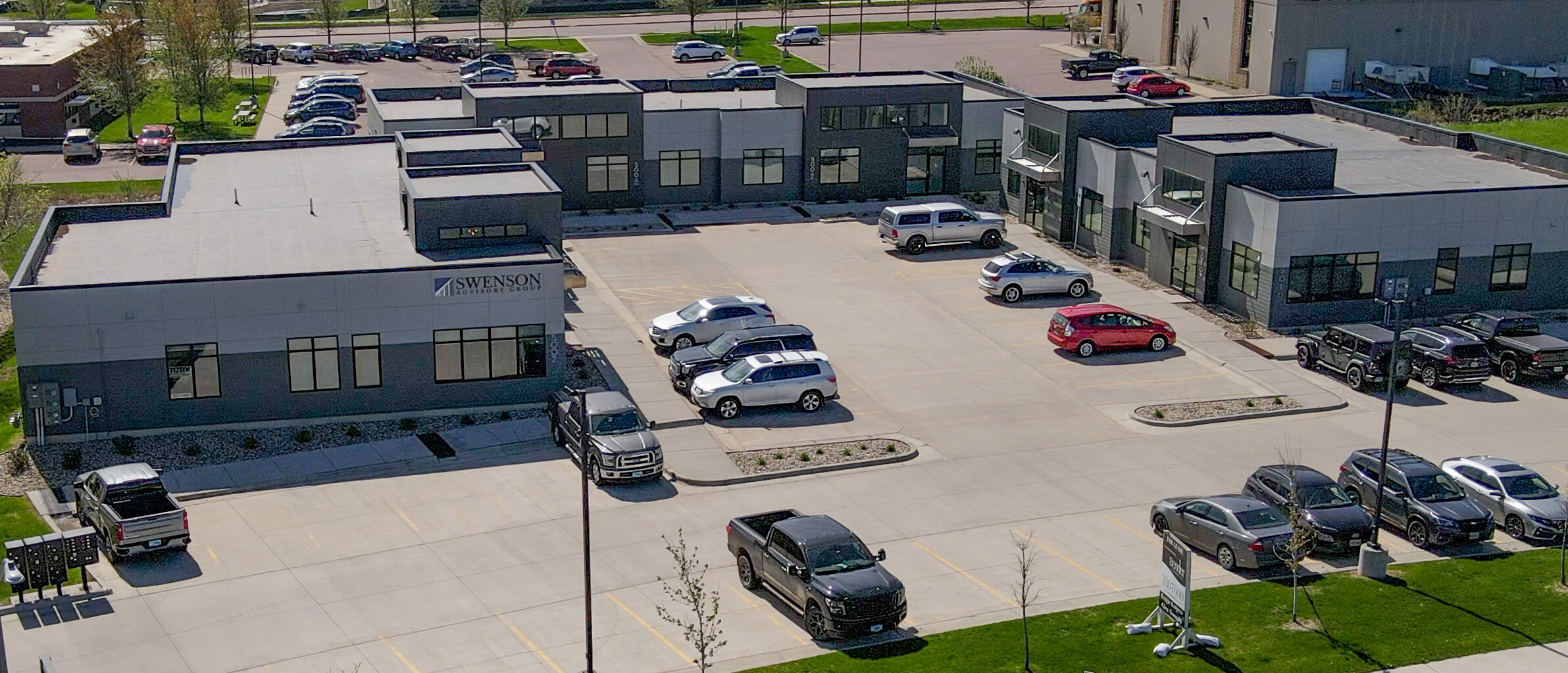 Grey Office Building Center with parking lot