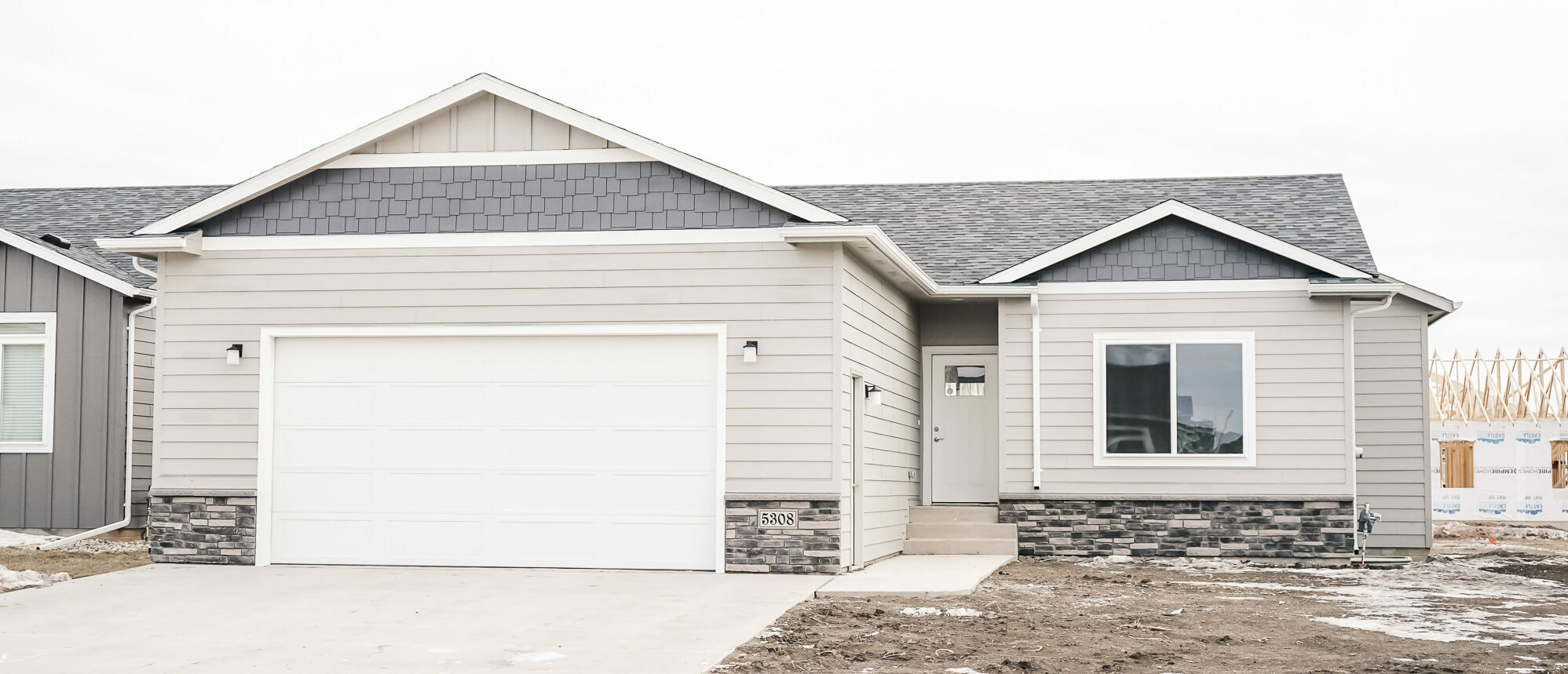 Single Family home with white front door and garage door and large front window