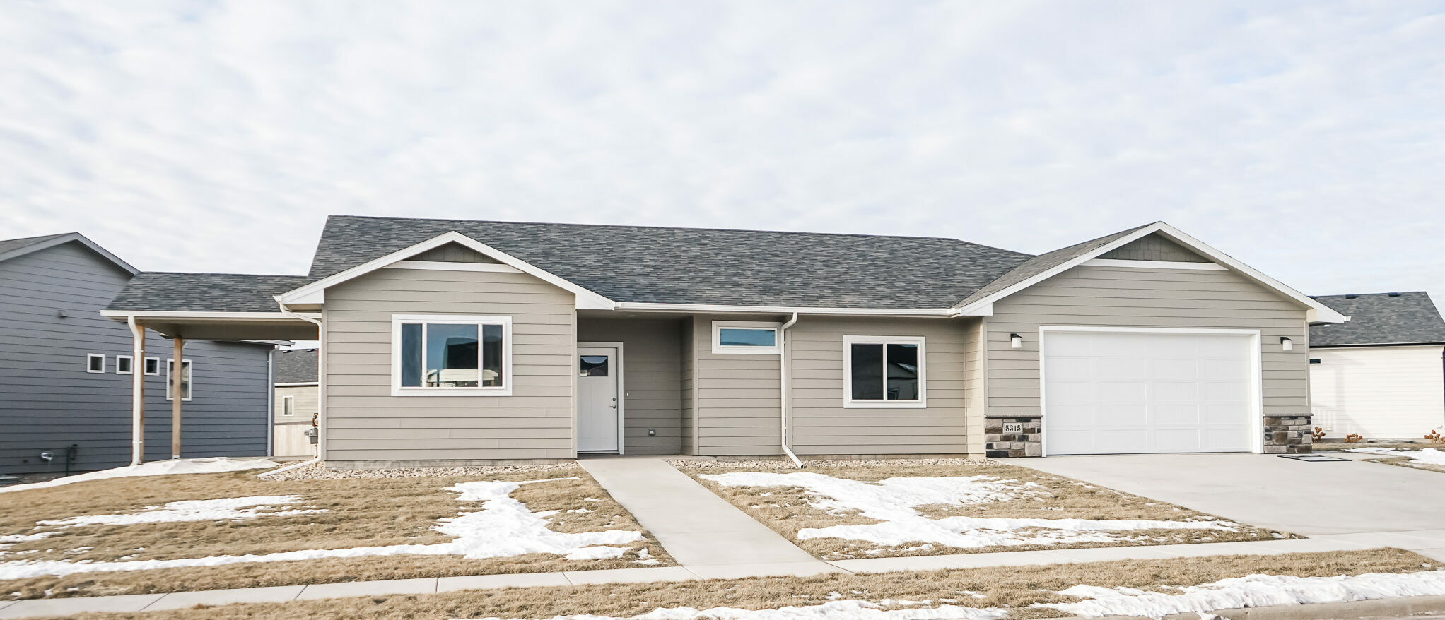 Single Family Home with White Front Door and Two Stall Car Garage