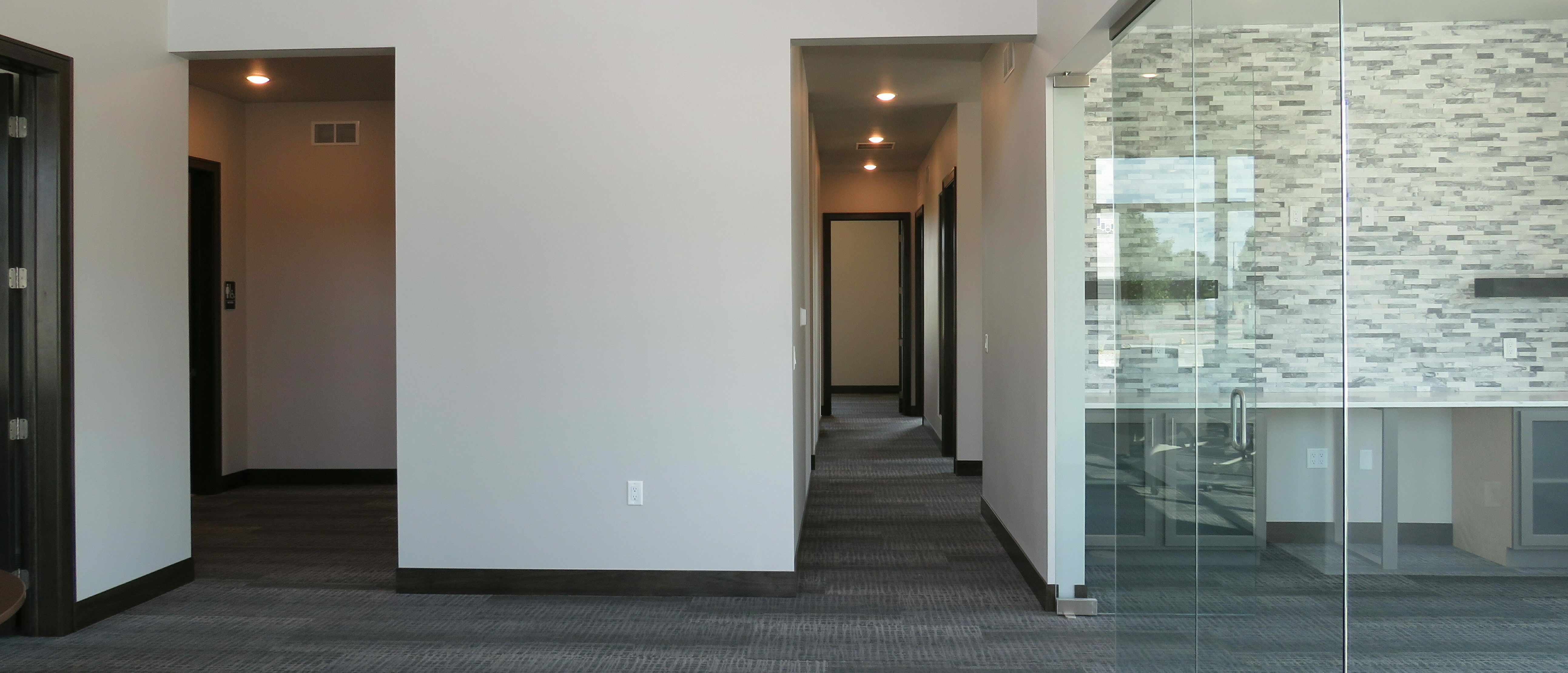 Office Welcome Area with glass meeting room to the right of the entrance