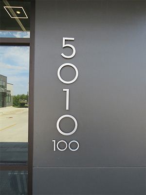 An office space that features modern lettering for the exterior address numbers.